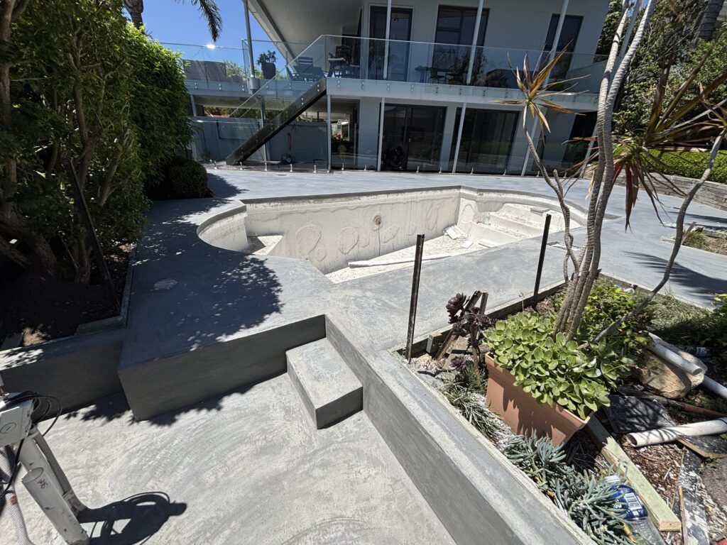 Architectural grey Geostone concrete pool surround with cantilevered coping edge by Ocon Concrete Group, in Yowie Bay, Sydney.